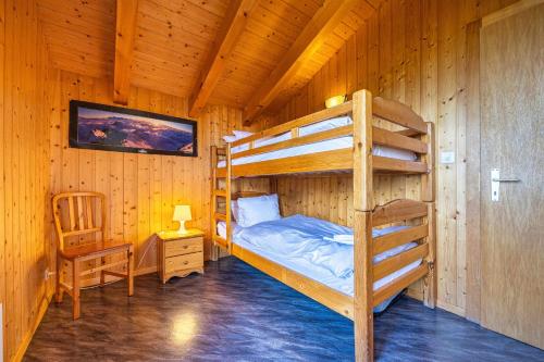 a bedroom with bunk beds in a cabin at Les 2 Sabots in Nendaz