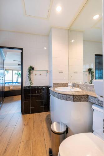 a bathroom with a sink and a large mirror at Kamala - The Club Residence -2 BR Pool View Residence in Kamala Beach