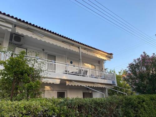 a building with a balcony on the side of it at Anastasia's Seaview apartment in Hanioti