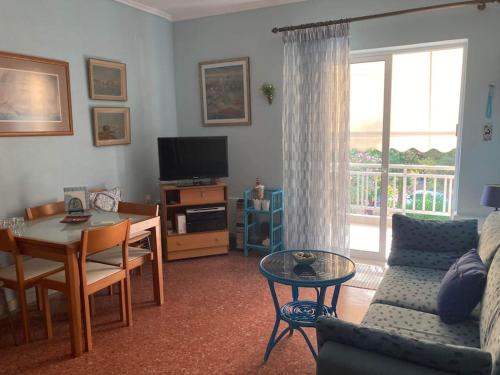 a living room with a couch and a table at Anastasia's Seaview apartment in Hanioti