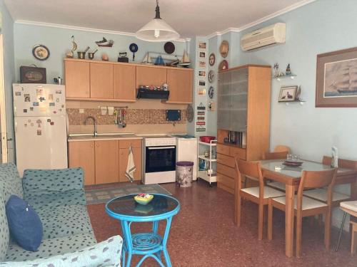 a living room with a table and a kitchen at Anastasia's Seaview apartment in Hanioti