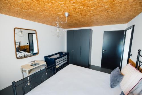 a bedroom with a bed with a mirror and a sink at La Forge de Diogne - luxury B&B and apartments in Crans-Montana