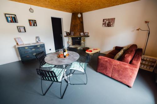 a living room with a table and a couch at La Forge de Diogne - luxury B&B and apartments in Crans-Montana