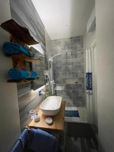 a bathroom with a sink and a shower at Montebello Luxury Apartment in Peschici