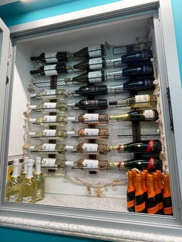 a refrigerator filled with lots of wine bottles at Montebello Luxury Apartment in Peschici