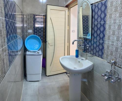 a bathroom with a sink and a toilet and a mirror at Ashour Tower Ramy Abdulla For Families only in Marsa Matruh