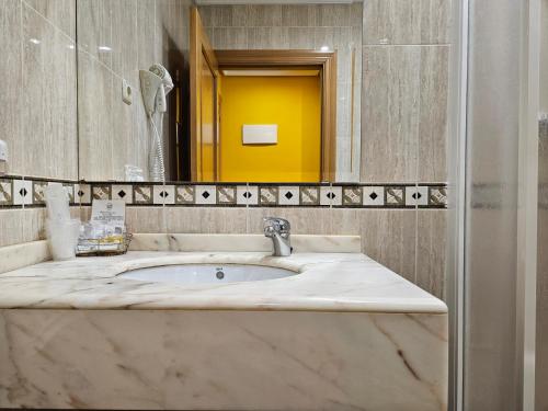 a bathroom with a sink and a mirror at Hotel Rural Casa Migio in Urbiés