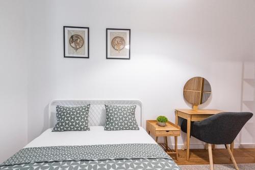 a bedroom with a bed and a desk with a chair at VERTIGO One Bedroom apartment - Free private parking-Fast WI-FI in Novi Sad