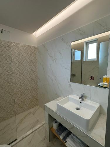 a bathroom with a sink and a mirror at Faliraki Star in Faliraki