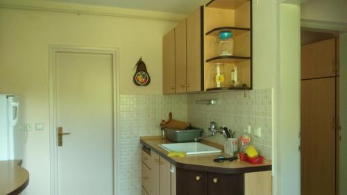 a kitchen with wooden cabinets and a sink at Country House Trnac in Tuhelj