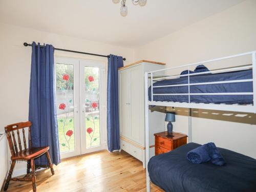 a bedroom with a bunk bed and a window at Palma in Holyhead