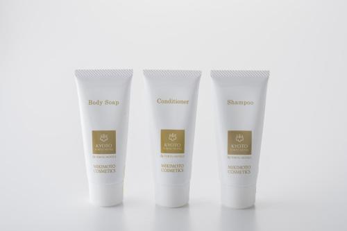 a group of four white sunscreen bottles on a white background at Kyoto Tokyu Hotel in Kyoto