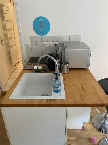 a kitchen counter with a sink in a kitchen at Studio quai de Valmy in Paris