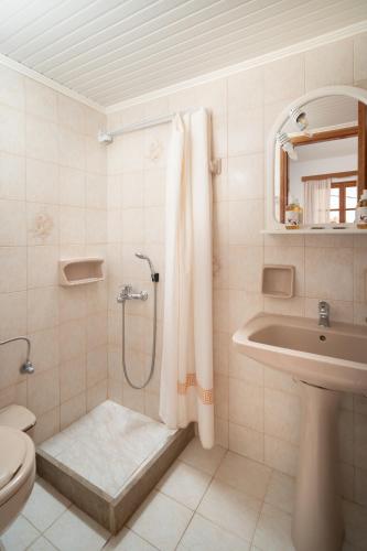 a bathroom with a shower and a sink and a toilet at Alta Vista Studios - ex Lekka's House in Monemvasia