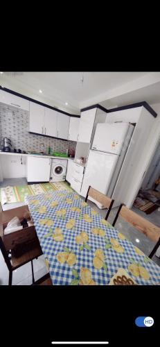 a kitchen with a table and chairs and a floor at Daire 2+1 in Dalaman