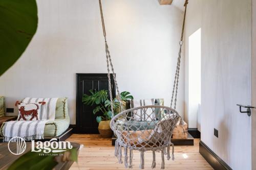 a room with a swing chair and a couch at StayLagom in Ballycastle