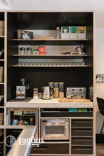 a kitchen with a counter with a microwave at StayLagom in Ballycastle