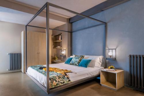 a bedroom with a canopy bed and a table at CasaCastello Barolo in Barolo