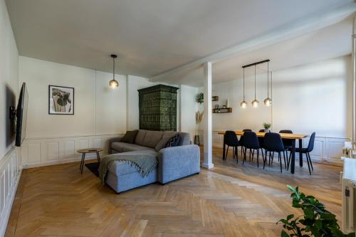 a living room and dining room with a couch and a table at Historische Wohnung im Herzen der Thuner Altstadt in Thun