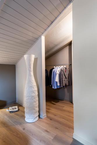 a white dress in a room with a closet at CasaCastello Barolo in Barolo