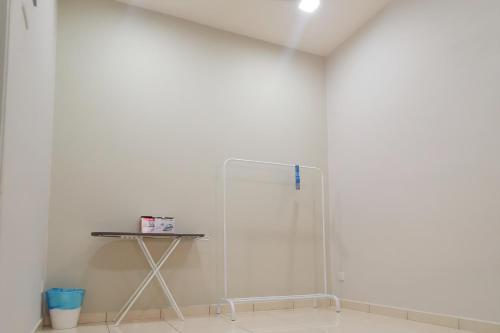 a white room with a mirror and a table at Relax Inn 200 旅安居 -3BR homestay near Alor Setar Mall in Alor Setar