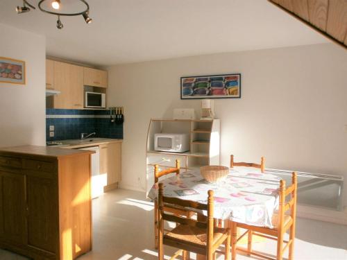 une cuisine avec une table et des chaises dans une cuisine dans l'établissement Duplex T3 au cœur de Saint-Lary-Soulan - 6 pers., balcon, parking, skis - FR-1-457-130, à Saint-Lary-Soulan