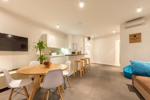 a kitchen and living room with a table and chairs at Nest Apartment in Split