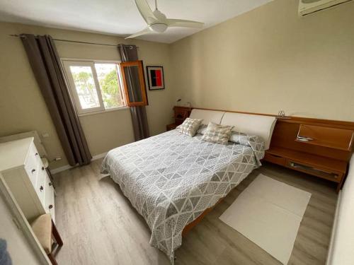 a bedroom with a bed and a ceiling fan at Apartamento Puerto Rico - Primera línea de playa in Mogán