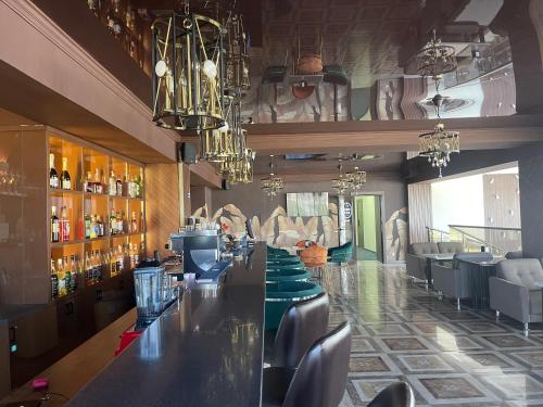 a bar in a restaurant with a long counter at квартира в ЦО Радуга Иссык куль 4, Raduga Issyk Kul, Sary Oy in Chon-Sary-Oy