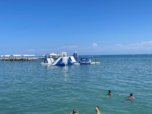a group of people in the water with a slide at квартира в ЦО Радуга Иссык куль 4, Raduga Issyk Kul, Sary Oy in Chon-Sary-Oy