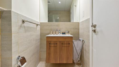 a bathroom with a sink and a shower at Delightful Staycation in Masdar in Al Qurayyah