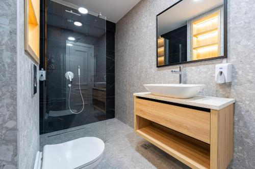 a bathroom with a sink and a shower at Bonita Residence in Dobrota