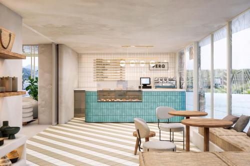 a living room with a kitchen with a table and chairs at Hyde Ibiza in Cala Llonga