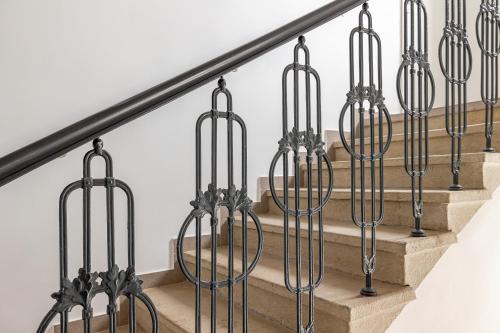 a set of stairs with wrought iron railings at Villa Matylda in Mariánské Lázně
