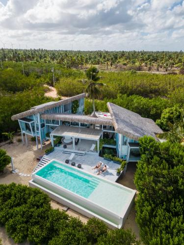 an aerial view of a house with a swimming pool at Beach Houses Moitas in Amontada