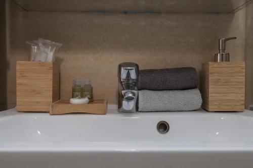 a sink with a faucet and towels on top of it at [Roma Termini] - Suite elegante in Rome