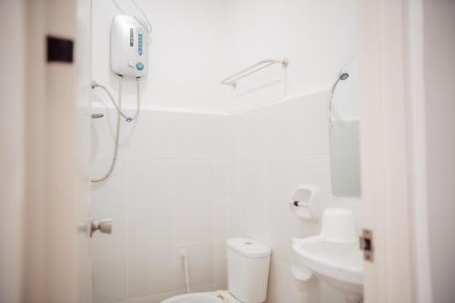 a bathroom with a shower and a toilet and a sink at Greendales - New Extension in Puerto Princesa City