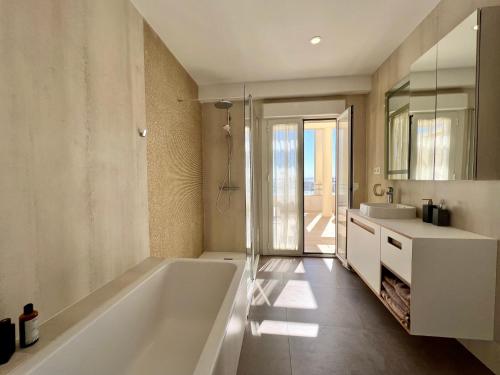 a bathroom with a large tub and a sink at Plaza Mina Suites - Adults Recommended by Luxury Suites Cadiz in Cádiz