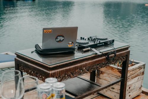 a laptop computer sitting on a table next to the water at Lan Ha Floating Homestay in Cat Ba