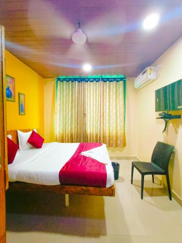a bedroom with a bed and a chair and a window at sonai POWERED BY PEACEFUL STUDIO in Panvel