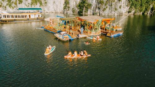 a group of people on rafts in a water park at Lan Ha Floating Homestay in Cat Ba