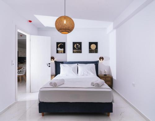 a bedroom with a large bed with white walls at Dream on in Kalamaki Heraklion