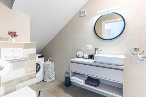 a bathroom with a sink and a mirror at New 4 star apartment M&A in town Cres in Cres