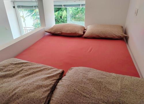 Habitación con 2 camas y suelo rojo. en Sončni apartma, en Ankaran