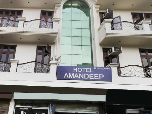 a hotel amander sign on the side of a building at OYO 48765 Hotel Amandeep in Ludhiana