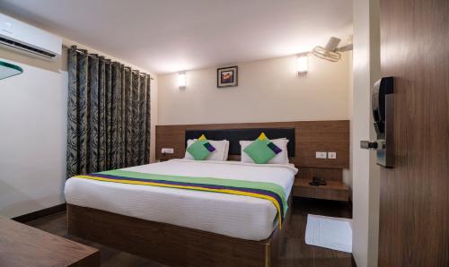 a bedroom with a large bed in a room at Treebo MVP Grand in Visakhapatnam