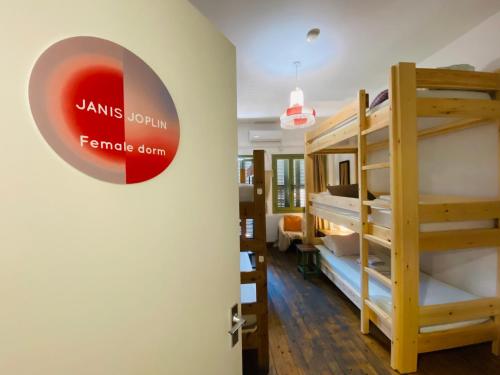 a room with bunk beds and a door with a sign at Lima Sol House in Limassol