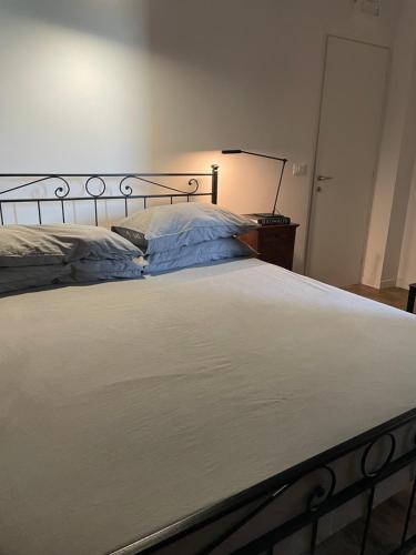 a bed in a bedroom with a white bedspread at THE RANCH Apartment 3 Capalbio in Pescia Romana