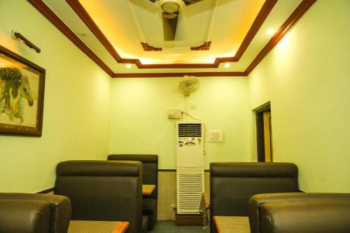 a waiting room with chairs and a ceiling at S S RESIDENCY in Padubidri