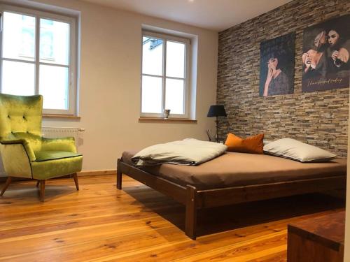 a bedroom with a bed and a brick wall at Künstlerapartment Potsdam in Potsdam